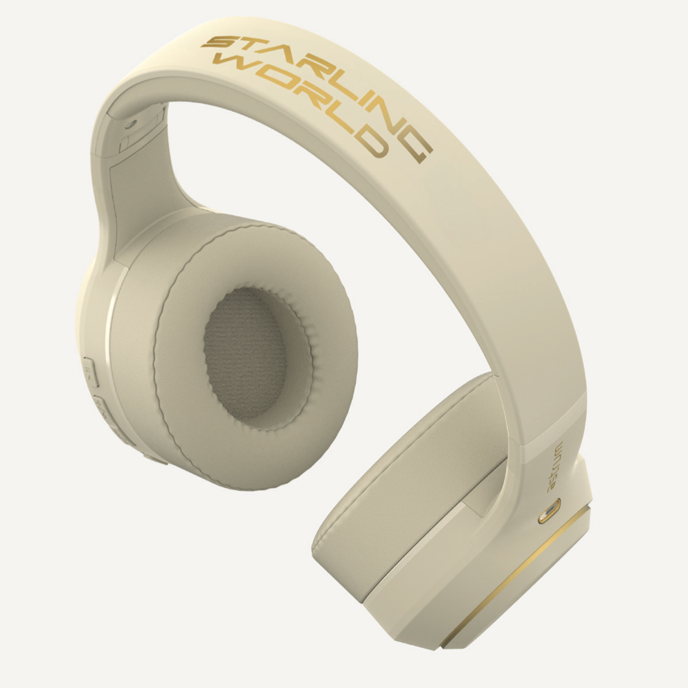 Starling World wireless headphones in cream, gold Starling World logo across headband